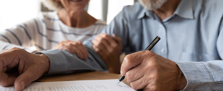 Elderly couple reviewing probate documents with attorney
